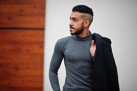 Portrait of stylish arab beard man wear grey turtleneck and black jaket. Arabian model guy.