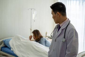 Fototapeta premium Asian medical doctor wearing white gown stethoscope standing with death patient on hospital bed 