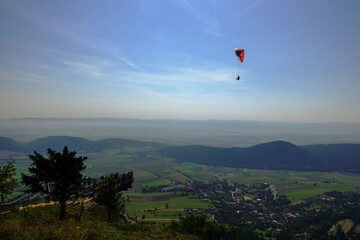 single paraglider over the sky walk with many hikers