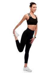 Fototapeta na wymiar Slim athletic caucasian woman in sport wear doing stretching exercise in white isolated background