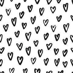 seamless pattern with hand drawn hearts on white background for Valentine's day decor. Black brush strokes on white background for wrapping paper, textile prints, packaging, etc. EPS 10