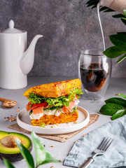 Waffle sandwich with salmon, green salad, cottage cheese