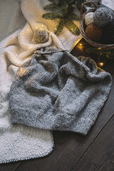 Fototapeta na wymiar Hand knitting with needles and yarn balls in a basket on a dark background.