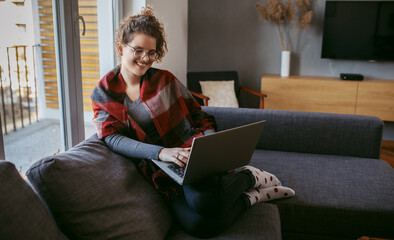 Young woman working at home. Young businesswoman working on laptop. Businesswoman working from home.
