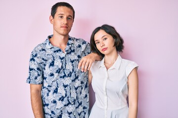 Beautiful couple wearing casual clothes relaxed with serious expression on face. simple and natural looking at the camera.