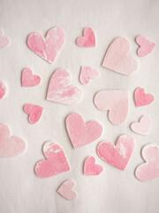 Fototapeta premium Paper hearts painted in pink watercolor on a white background