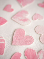Fototapeta premium Paper hearts painted in pink watercolor on a white background