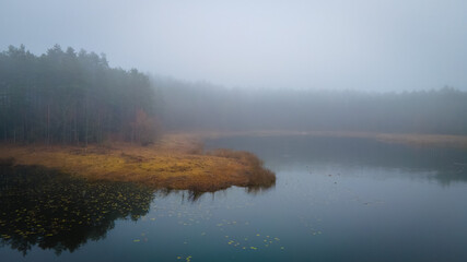 Aerial view of foggy lake in Lithuania by drone