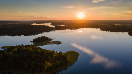 Fototapeta na wymiar Aerial view of beautiful sunset near lake in Lithuania by drone