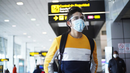 young man with mask and face mask at the airport terminal virus protection mask new normal tourist     