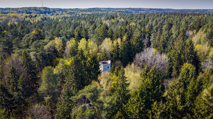 Aerial view of old water tower in the middle of the the forest by drone. 