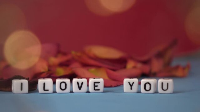 I love you against the background of rose petals . Valentine's Day. Background concept of love and beauty