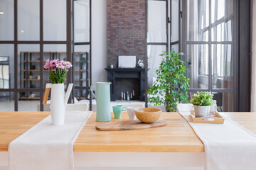 trendy modern design two-level apartment with large high windows. The stylish living room and kitchen in bright colors are undressed by a glass partition. bedroom on the second floor.