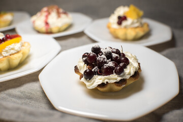 tartlets made of dough with cream and fruit