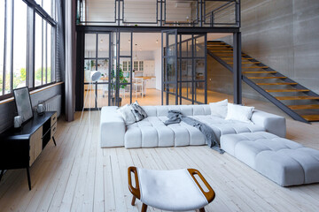 trendy modern design two-level apartment with large high windows. The stylish living room and...