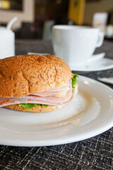 croissant bread with ham and cheese with coffee.