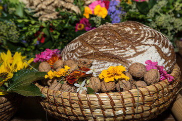 Loaf Of Bread In Old Bread Basket With Nuts And Flowers