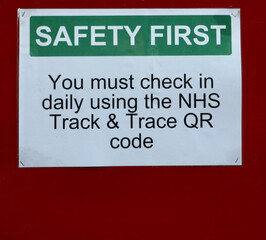 Track and trace warning notice advising check in using QR code