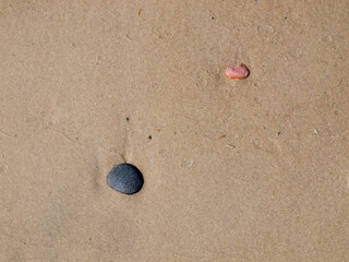 Fototapeta na wymiar Stones on the sand of the beach.