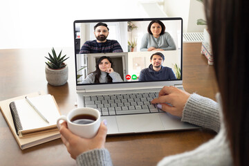 Young businesswoman work at home and virtual video conference meeting with colleagues business people, online working, video call due to social distancing at home office