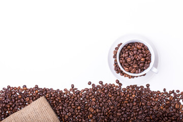 Naklejka premium top view of White cup filled with freshly roasted coffee beans