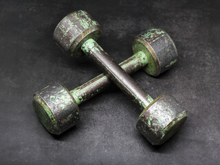 old rusty dumbbell on a black background