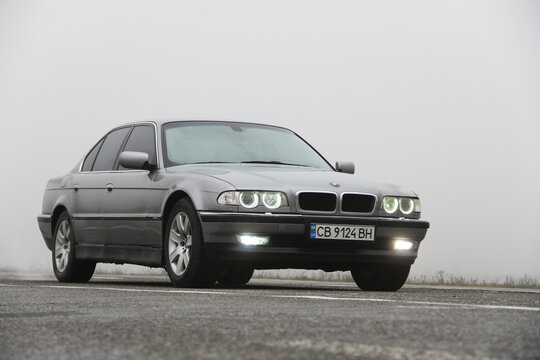 Chernigov, Ukraine - January 6, 2021: Old car BMW 7 Series (E38) on the road against a background of fog. Gloomy weather. Bmw and fog