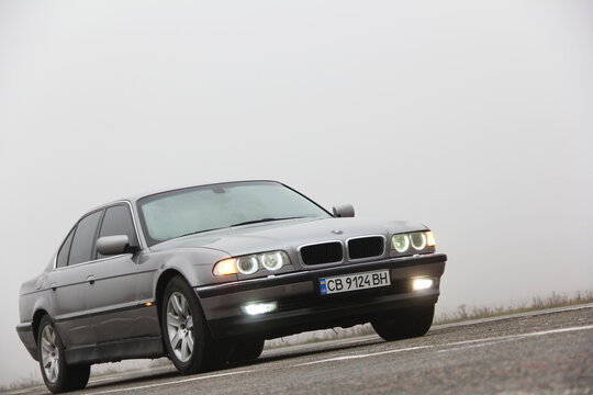 Chernigov, Ukraine - January 6, 2021: Old car BMW 7 Series (E38) on the road against a background of fog. Gloomy weather. Bmw and fog