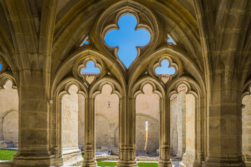 the ogival arch of the gothic cloister in the La Chaise Dieu abbey in Auvergne, France