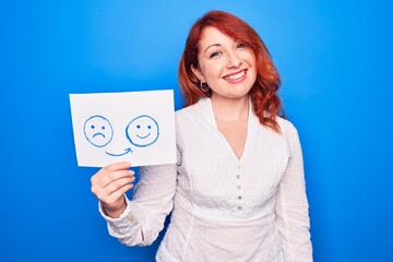 Redhead coach woman asking for depression holding paper with emotion change message looking positive and happy standing and smiling with a confident smile showing teeth