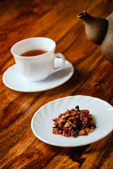 Black tea with fruit and cup with teapot