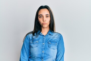 Obraz premium Young hispanic woman wearing casual denim jacket depressed and worry for distress, crying angry and afraid. sad expression.