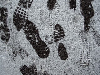 Shoeprints in snow - danger walking in the snow. Footprints Texture.