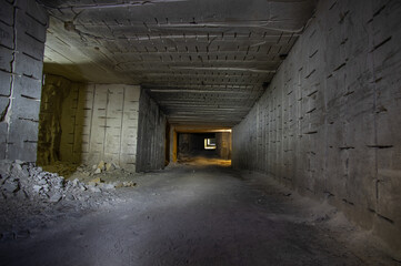 Fototapeta na wymiar Abandoned tunnel gallery of white limestone mine