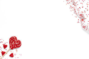 Red sweet tasty lollipops and chocolate candies in shape of heart with confetti. Valentine template. Isolated