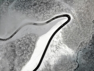 Mountain road in winter drone view