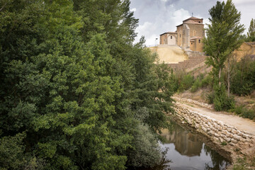 Fototapeta na wymiar church of Nuestra Senora de Belen and the Carrion river in Carrion de los Condes, province of Palencia, Castile and Leon, Spain