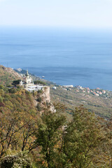 Fototapeta na wymiar Scenic autumn view from the top of the mountain Baydar gate to the Foros church and coastline of Black sea in Crimea