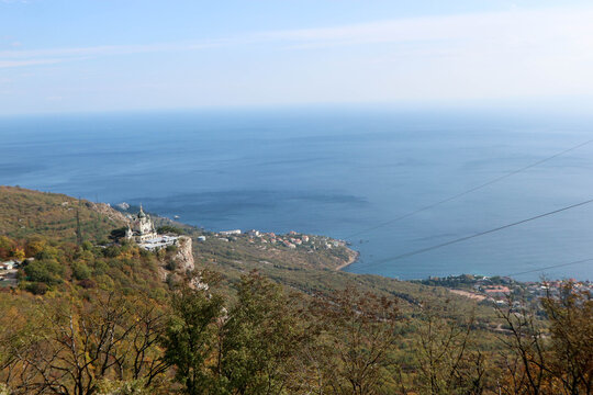 Scenic autumn view from the top of the mountain Baydar gate to the Foros church and coastline of Black sea in Crimea