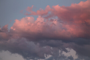 Natural color dramatic dawn or dusk sky with painterly yellow, pink and blue clouds with horizon, taken with normal 50 mm lens for sky replacement