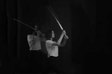 black and white silhouettes of a girl with a sword in motion