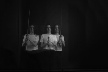 black and white silhouettes of a girl with a sword in motion