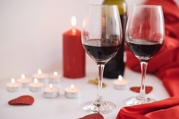 Two glasses of red wine and candles create a romantic, unforgettable evening for lovers. In Lovely Valentine day in 14th February get a surprise. Gifts, surprises, declarations of love