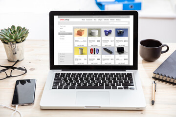 Online shop website design template on a computer monitor, office desk background.