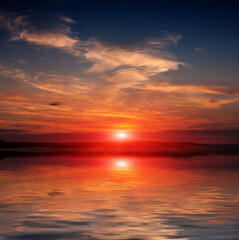 Fototapeta na wymiar sunset over lake water surface