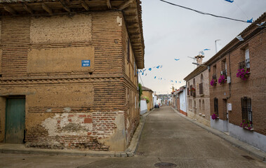 a street with typical houses in Calzadilla de la Cueza (municipality of Cervatos de la Cueza), province of Palencia, Castile and Leon, Spain