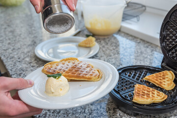 Sweet Waffle Hearts With Vanilla Ice Cream And Garnished With Lemon Balm