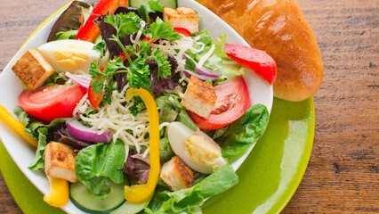 Salad. Garden Salad. Classic American or French restaurant salad made with kale, Arugula, almonds, blueberries, walnuts, tomatoes, bacon, blue cheese, eggs, avocado, tossed with olive oil.