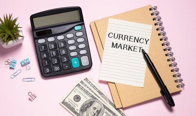 Text Currency Market on notepad with office tools, pen on financial report