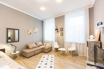 Fototapeta na wymiar interior photography, large living room with bed, in a modern style, in beige light colors